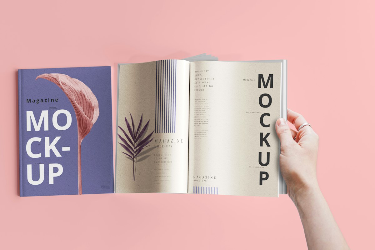 A hand holding open a book displaying a brand style guide mockup